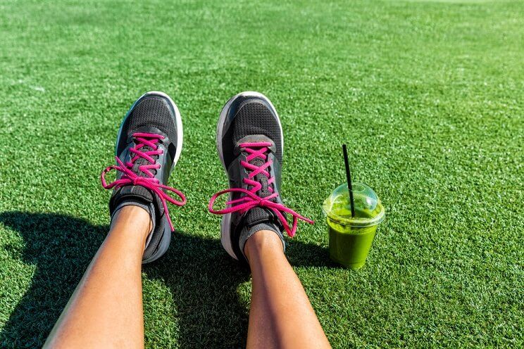 sneakers and green smoothie after a workout