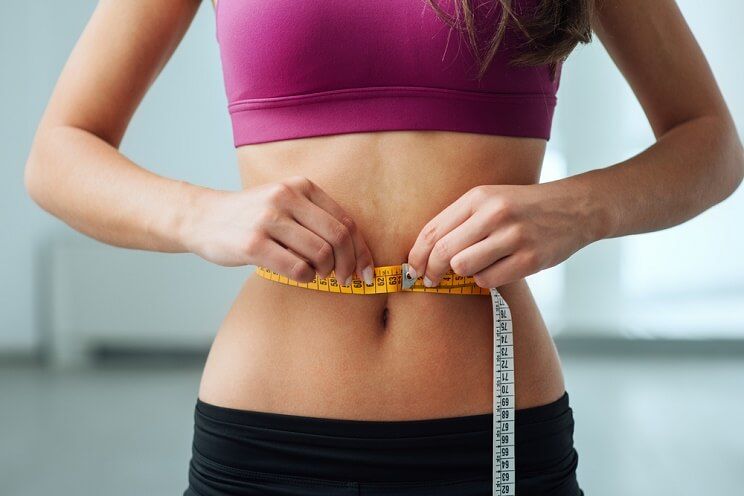 woman measuring waist