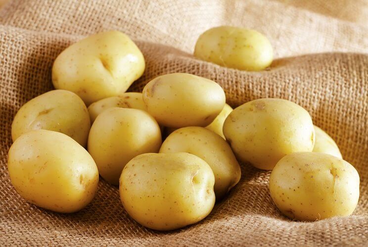 white potatoes on burlap