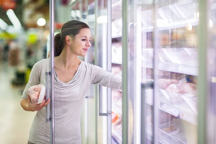 woman shopping freezer section