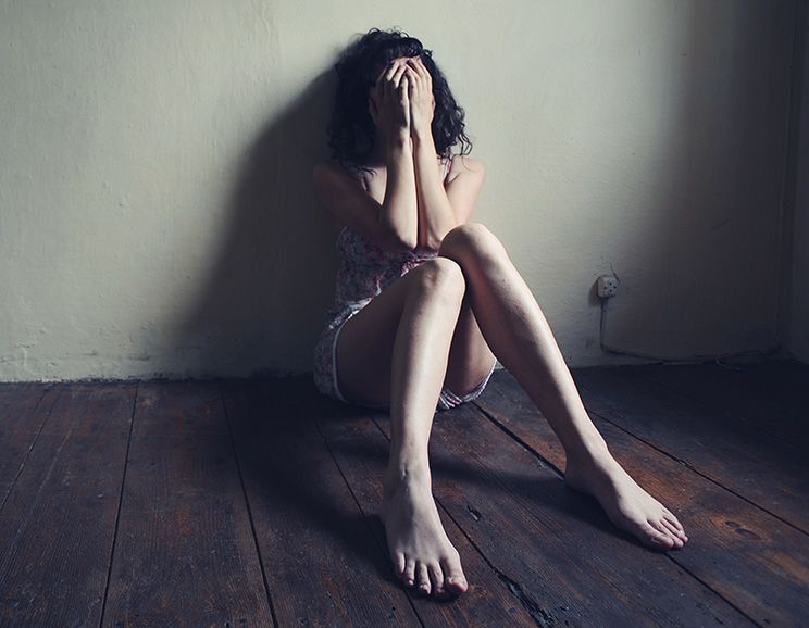 depressed girl sitting on the floor