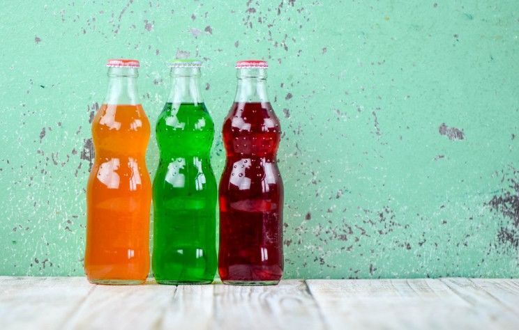 colored soda in clear bottles
