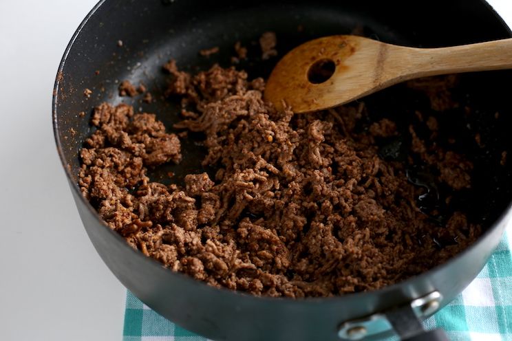 beef cooking in a large skillet