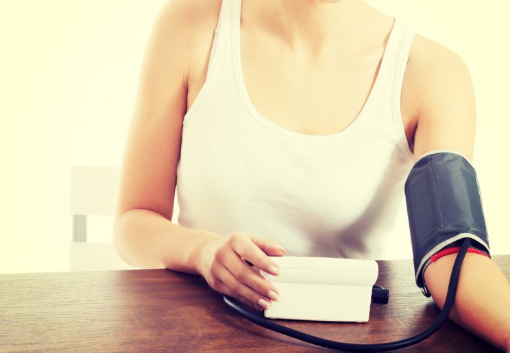 Woman measures her blood pressure