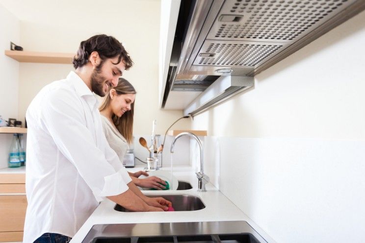 Young couple doing dishes in the kitchen