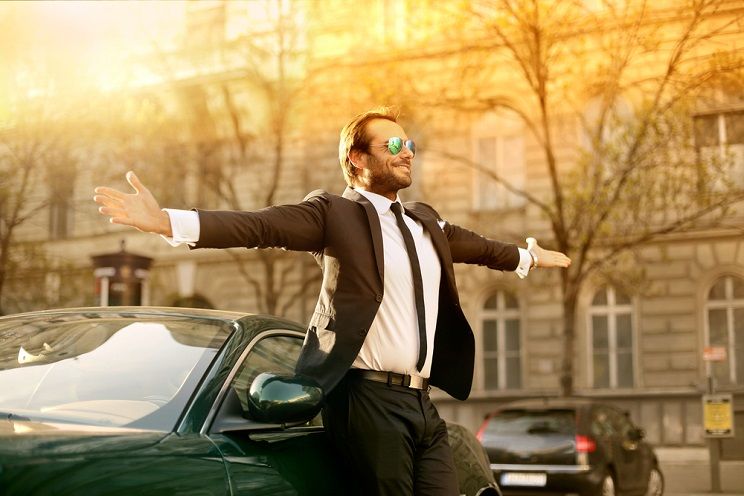 successful man in front of his expensive car