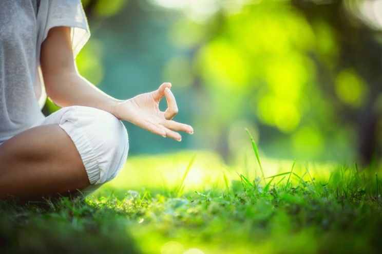 woman meditating in the park