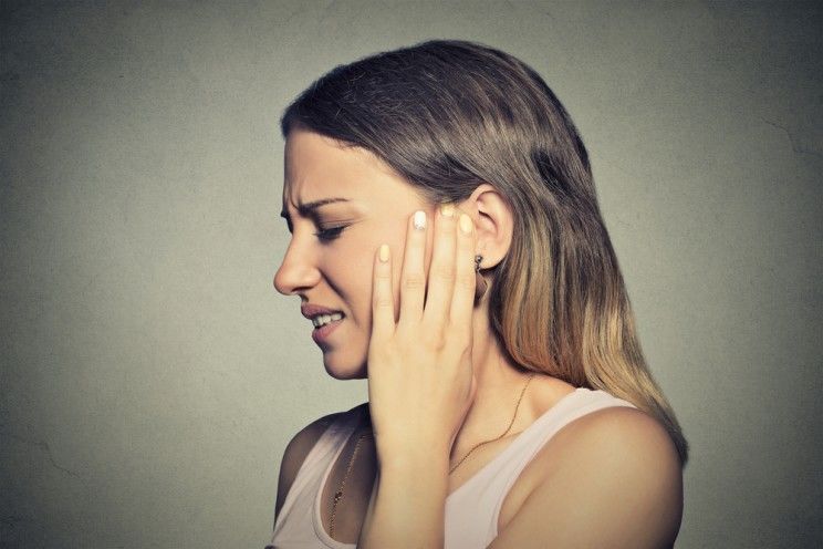 young woman with ear pain