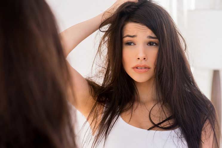 hungover woman looking in the mirror