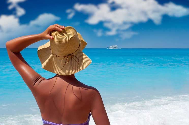 woman on the beach wearing a sunhat
