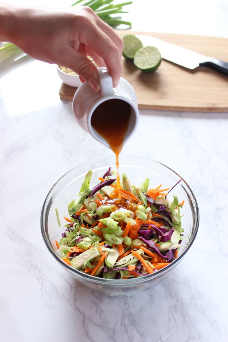 vinaigrette poured over brussels sprout salad