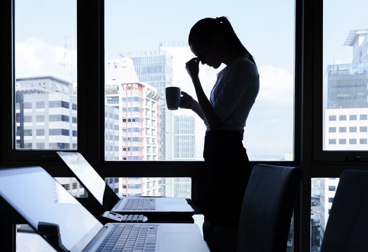 upset woman at work with coffee