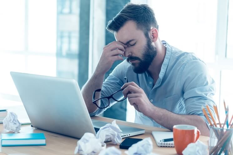 man tired at his desk