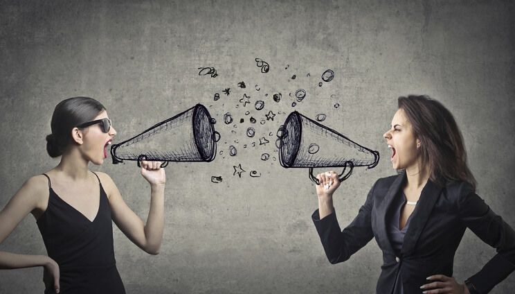 two women shouting at each other with megaphones