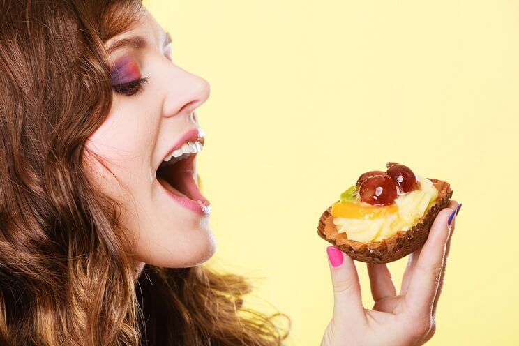 woman eating a tart