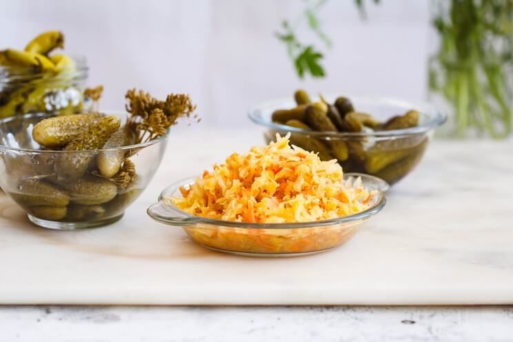 kimchi and pickles in glass bowls