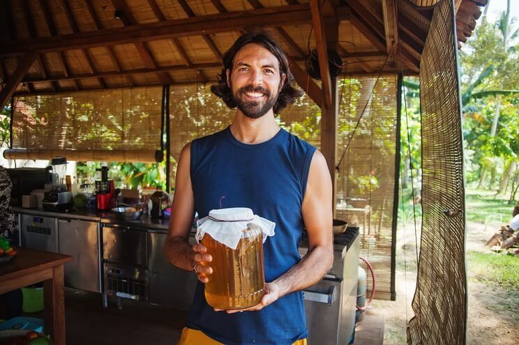 man with kombucha outside