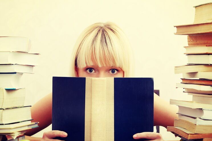 girl behind a book