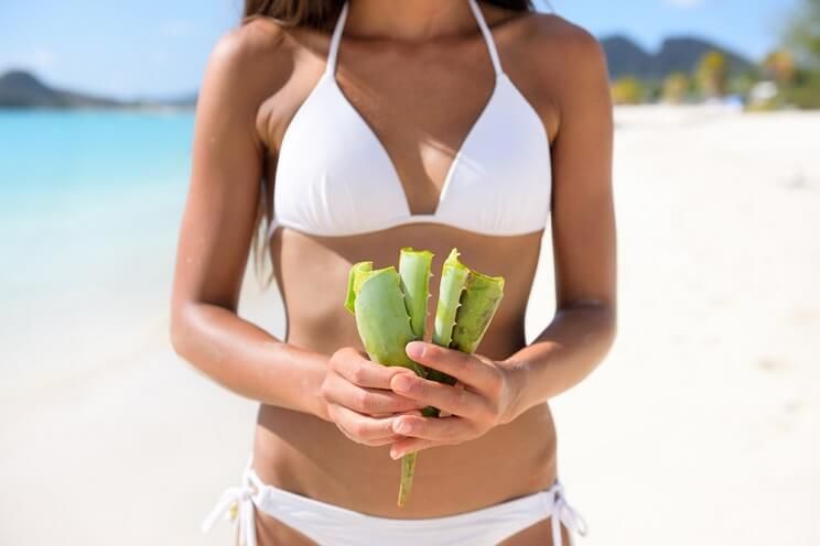 woman on the beach with aloe vera