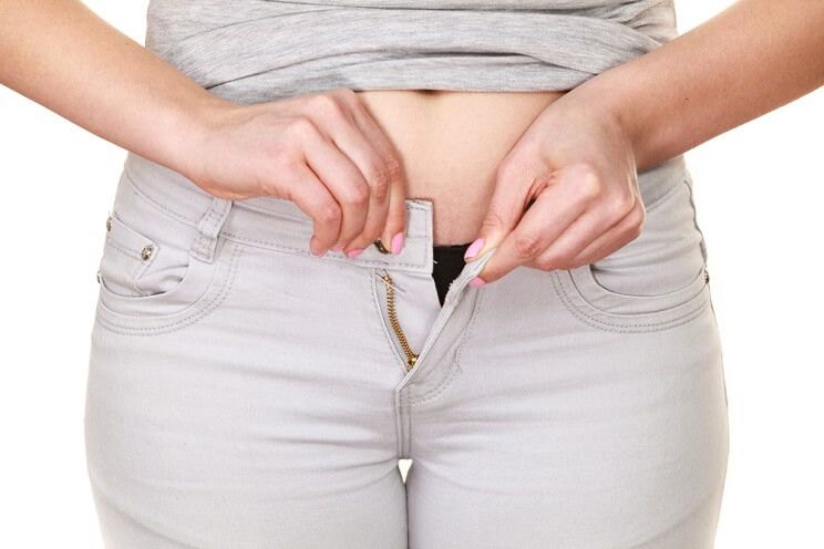 overweight woman buttoning pants