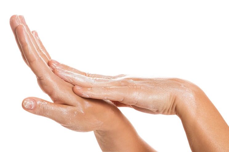 woman moisturizing hands