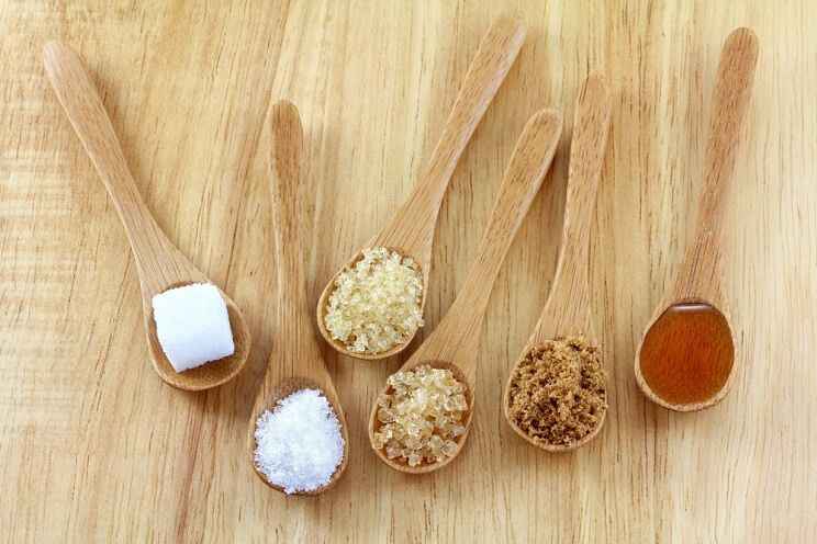 wooden spoons of natural sweeteners