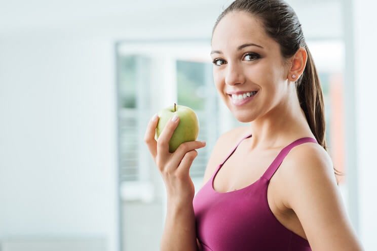 girl having apple before workout