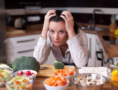 frustrated woman surrounded by healthy food