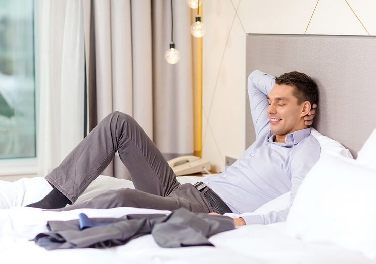 entrepreneur man in hotel bed