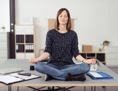 woman meditating on desk