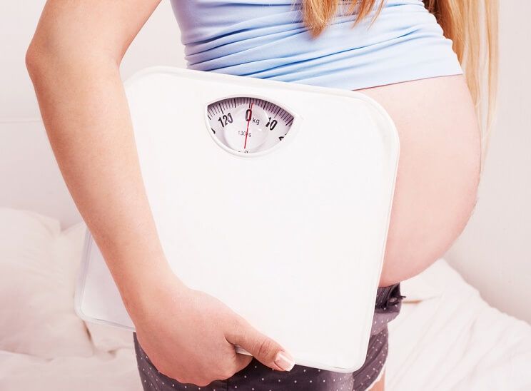 pregnant woman with scale
