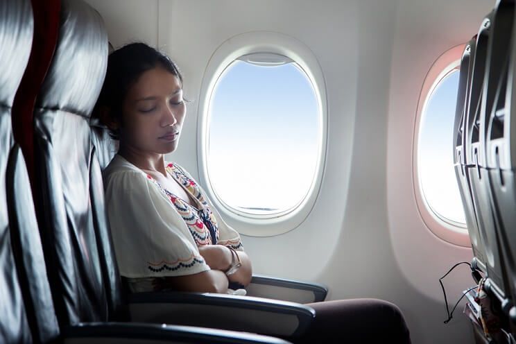 woman sleeping on plane