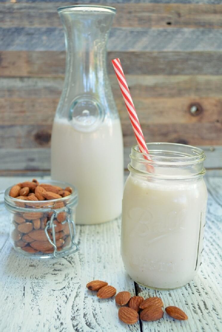 healthy almond milk with a straw
