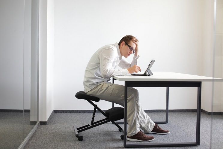 man hunched over computer