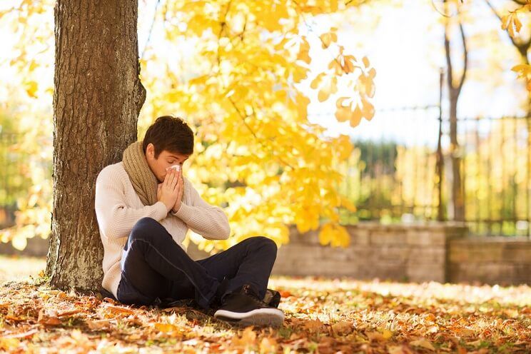 man with seasonal allergies in autumn