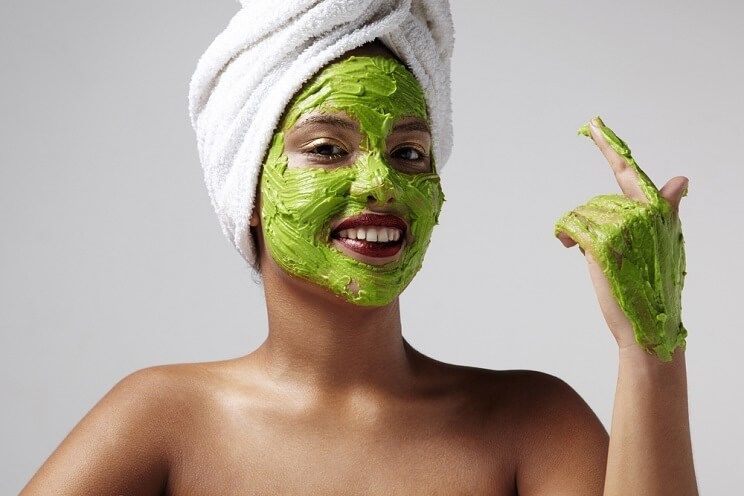 woman with an avocado mask