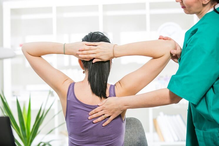 woman getting back examination