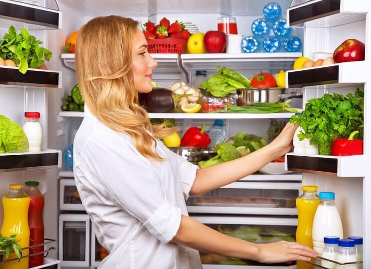 woman looking in fridge