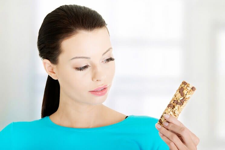 woman with granola bar