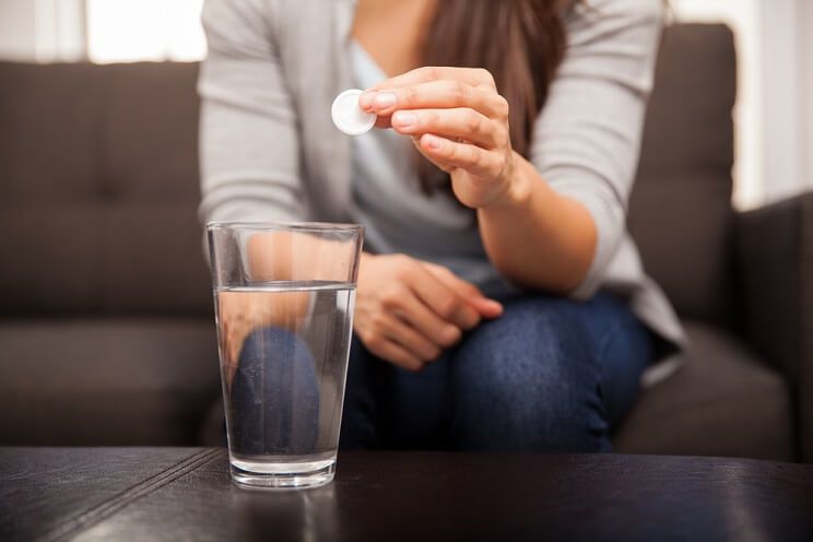 woman taking antacids