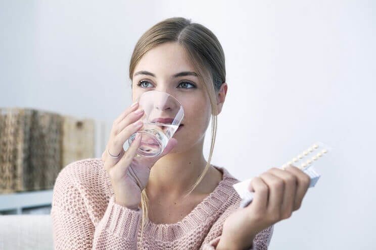 woman taking the pill