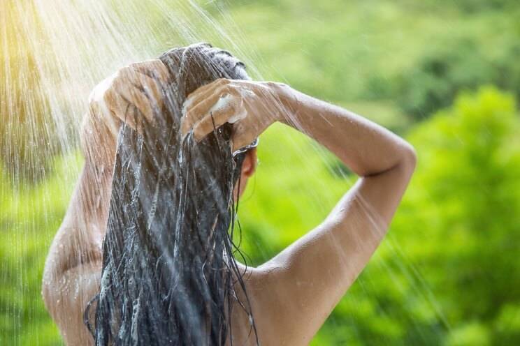 woman washing her hair outside