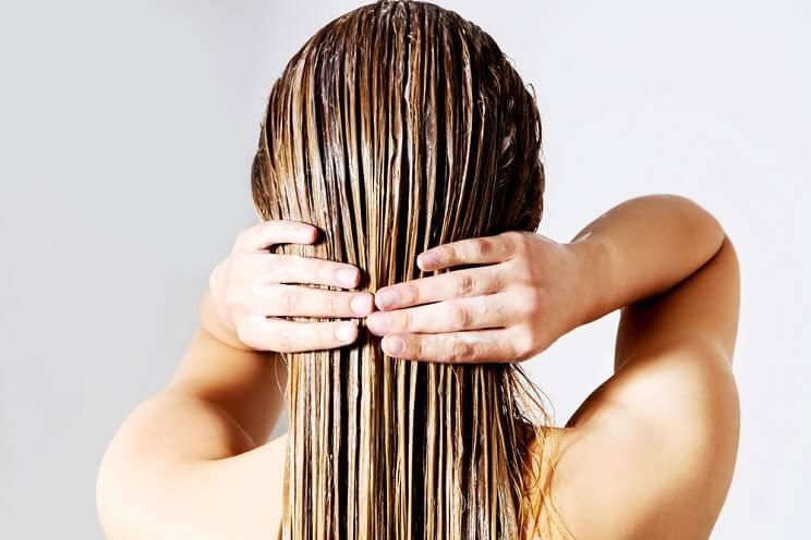woman conditioning hair