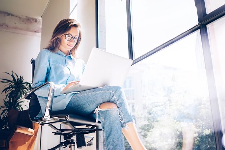 woman sitting by the window working