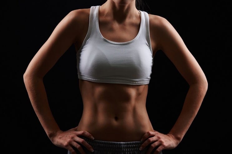 standing woman with toned abs