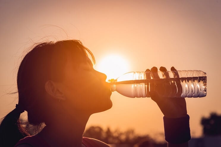 woman drinking bottled water