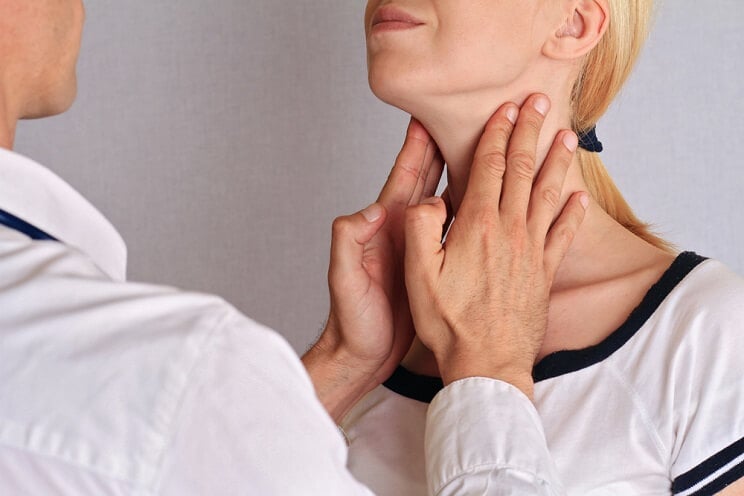 woman getting her thyroid checked