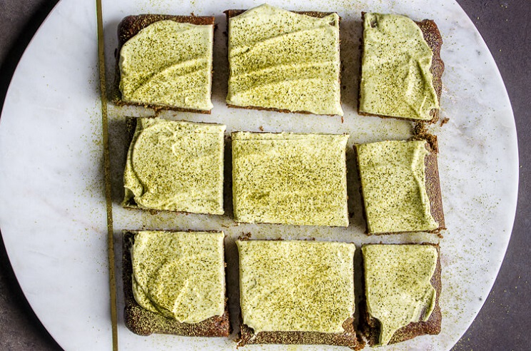 tray of matcha brownies with green tea frosting