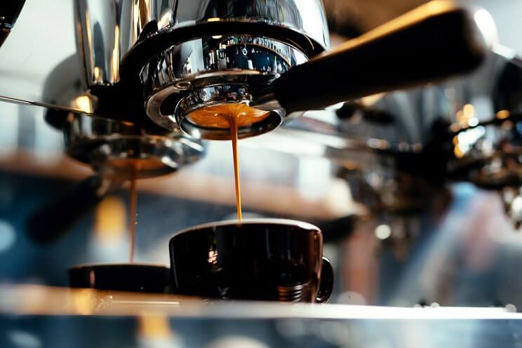 espresso being poured into mug