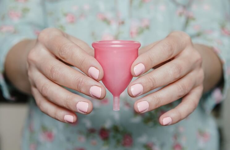 woman holding menstrual cup